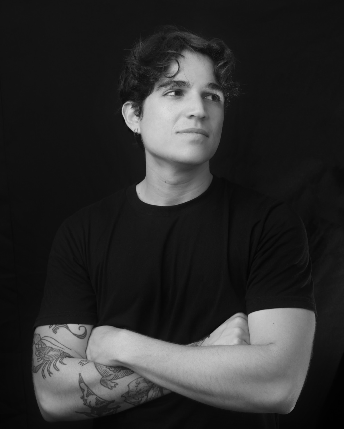 Black and white portrait of Wesley Melo, arms crossed